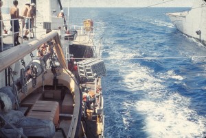 U.S. Coast Guard cutter PONTCHARTRAIN receiving 5-inch powder cases, UNREP (Rearm), Vietnam, 1970. Photo by LeRoy Reinburg, Jr.